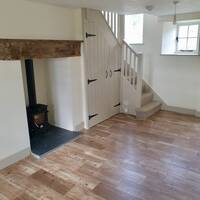 TY ISA LIVING ROOM WITH LOG BURNER AND STAIRS